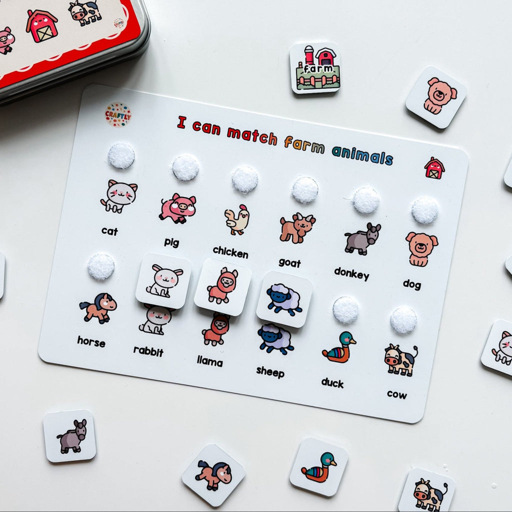 Educational game for matching farm animals with cards and buttons on a white surface.