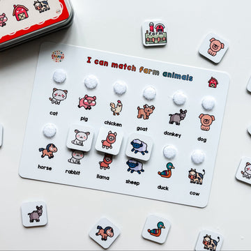 Educational game for matching farm animals with cards and buttons on a white surface.