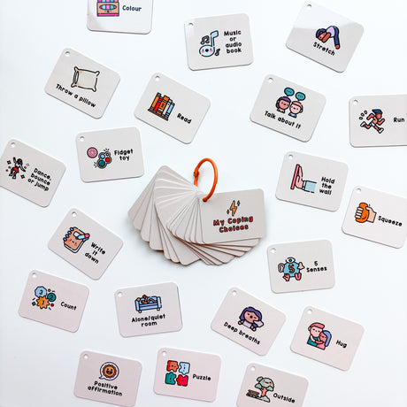 A collection of cards with various illustrations and text, tied together with an orange keyring, designed as a coping skills tool for emotional regulation.