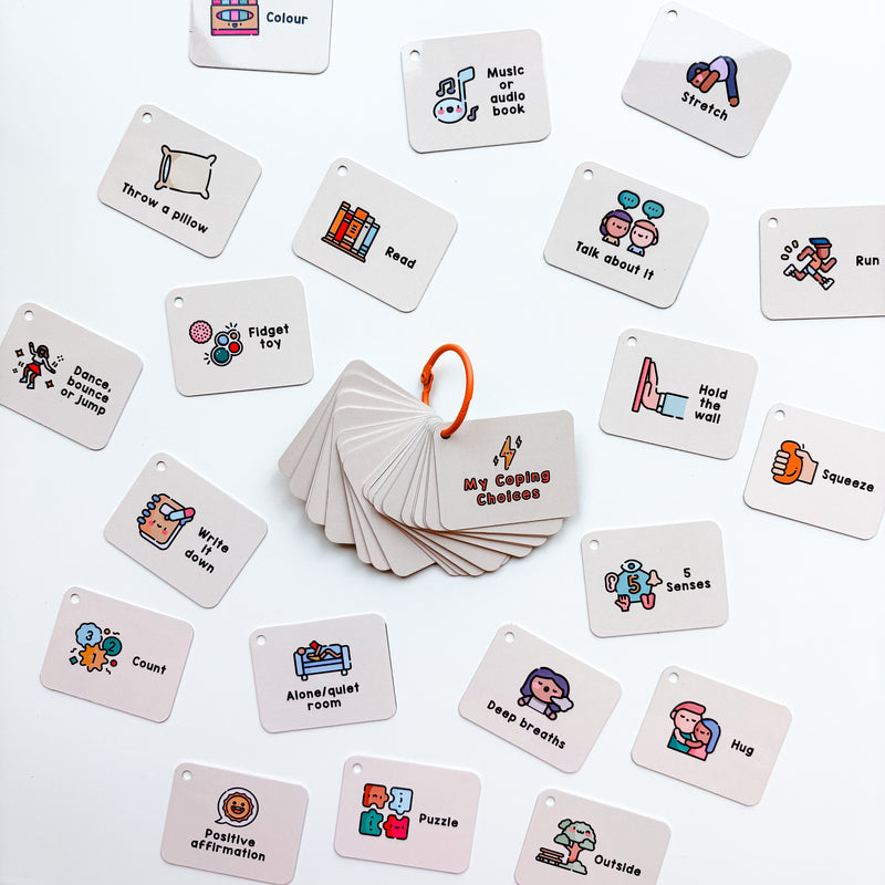 A collection of cards with various illustrations and text, tied together with an orange keyring, designed as a coping skills tool for emotional regulation.