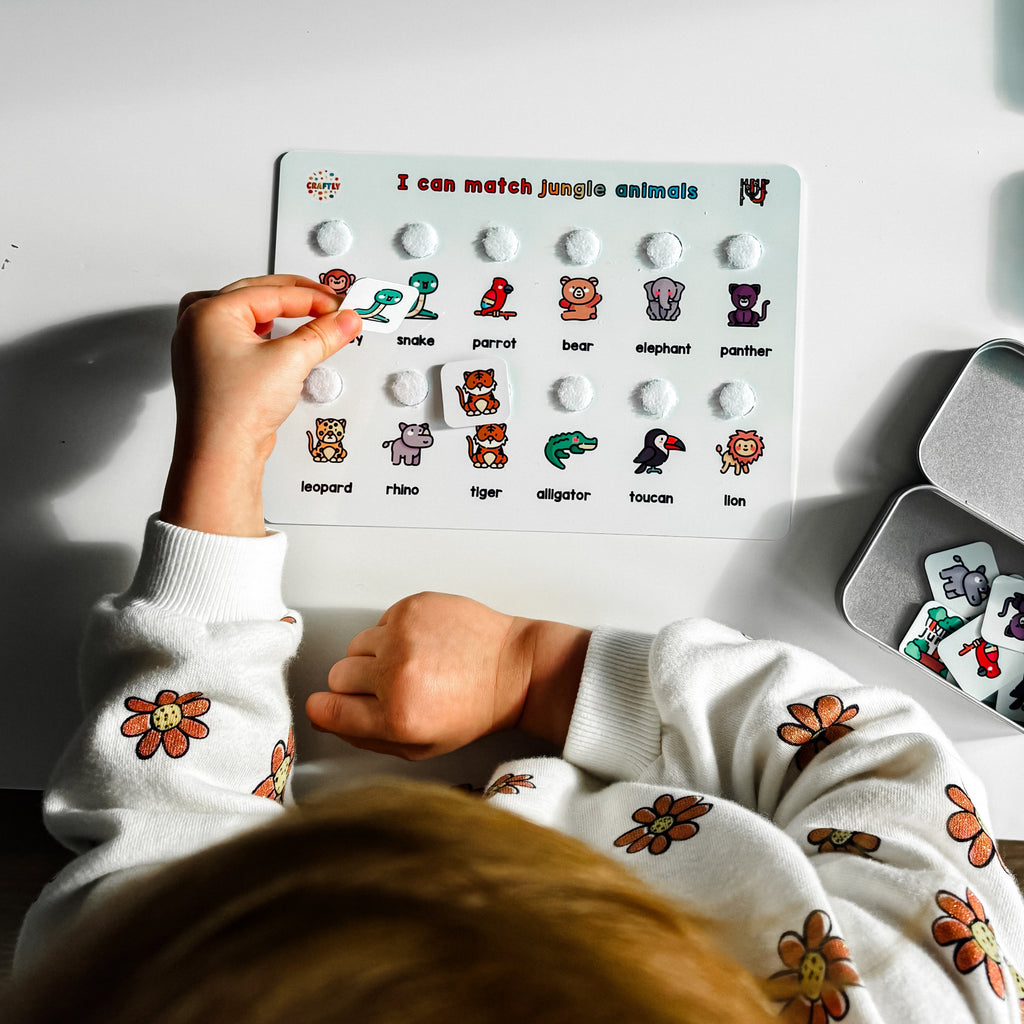 Child playing with educational matching board on a table
